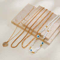Thumbnail for Boho Layered CZ Inlaid Sun Moon Pendant Evil Eye Pearl Chain Necklace Set - ArtGalleryZen