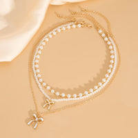 Thumbnail for Elegant Layered Enamel Bowknot Pendant Pearl Chain Necklace Set - ArtGalleryZen