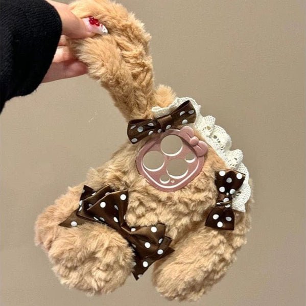 A plush bunny phone case with a polka dot bowknot and a soft brown color palette.